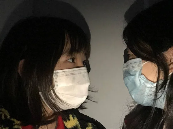a group of people in a medical mask