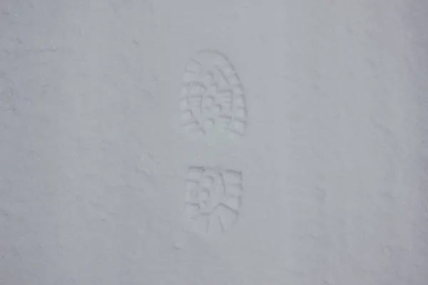 Walking shoes track on white snow