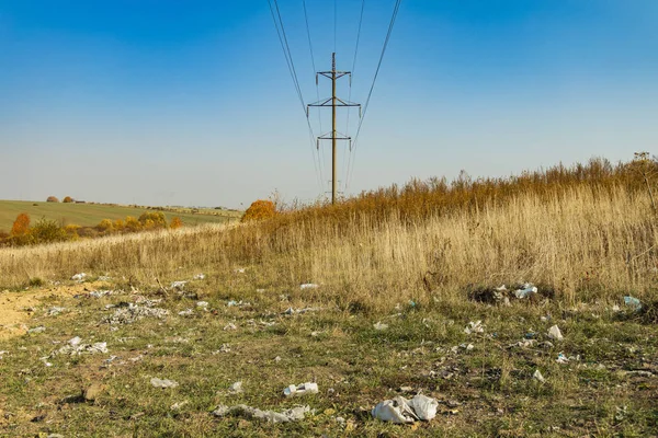 polluted field country side outdoor environment space with high voltage wires electric tower industrial landscaping object on background, ecological disaster situation concept photography