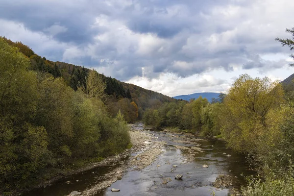 highland mountain forest moody scenery landscape river stream of autumn season weather time and gray cloudy sky background