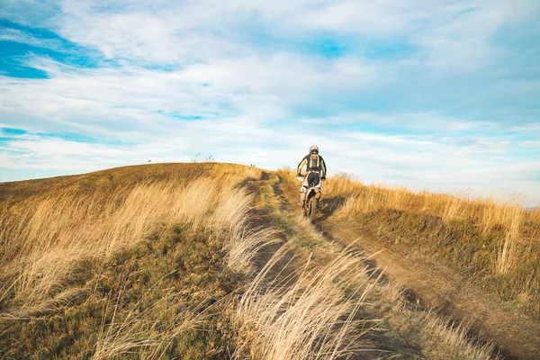 extreme life style person riding motorbike on highland valley dirt trail in rally racing competitions time, nature background environment with empty copy space for your text here