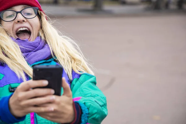 funny female selfie photography by young happy girl in autumn season warm cloth, copy space for text