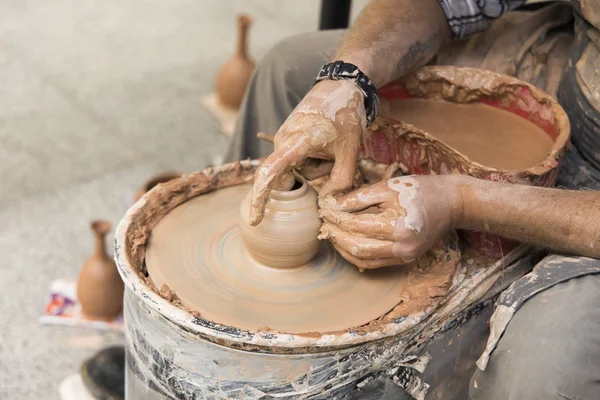 pottery life style hobby action male hands making clay vase dishes object  on a pottery machine