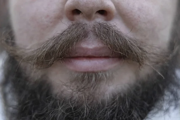 male face close portrait mouth with mustache and beard soft focus textured stubble