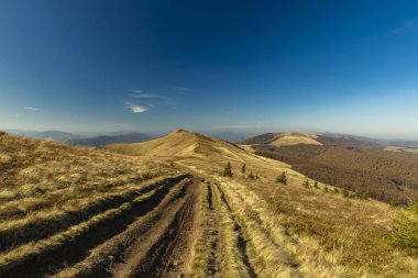 Sonbahar mevsiminde dağlık arazi manzarası fotoğrafçılığının toprak izi. İnsansız hava günü, metin için mavi gökyüzü arkaplan boş kopya alanı.