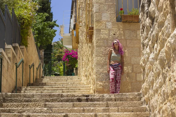 landmark travel photography of Jerusalem old city district stairs alley way stone buildings and posing young girl portrait in spring time