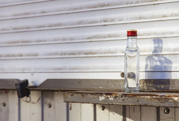 Alcoholism problem glass empty bottle in dirty ghetto back street district urban environment space — 스톡 사진