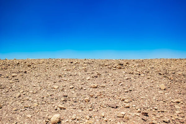 minimalism landscape of desert wasteland dry stone ground nature background horizontal board with empty blue sky empty copy space for text