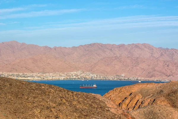 Gulf of Aqaba Red sea bay Middle East scenery landscape photography from drone in wilderness desert sand stone rocky country side area with view on a water and cargo ship in natural frame — Stock Photo, Image