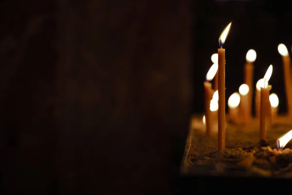 Soft focus candle fire religion service wallpaper pattern picture on dark background empty copy space for your text here — Stock Photo, Image