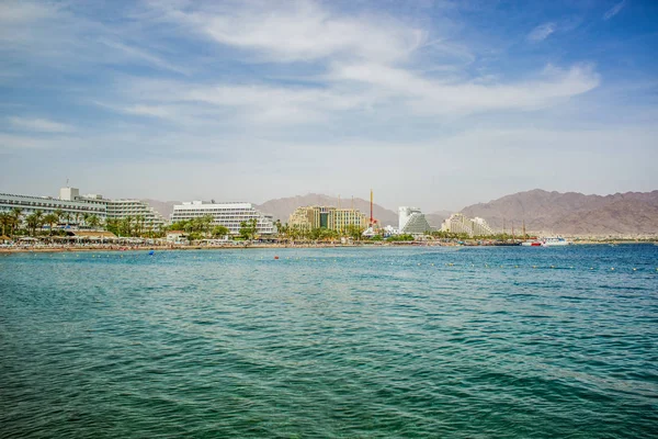 Summer time vacation season destination Middle East Israeli city Eilat on Red sea bay Gulf of Aqaba port hotel district waterfront side with water foreground, copy space for your text — Stock Photo, Image