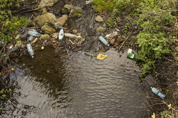 pollution ecological concept problem garbage things on shore of nature reservoir scenic top view