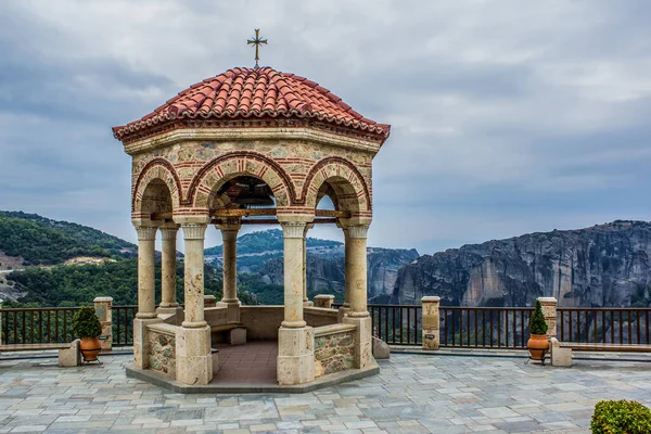 gazebo stone European medieval building object in observation yard space with highland mountain background landscape in gray cloudy weather
