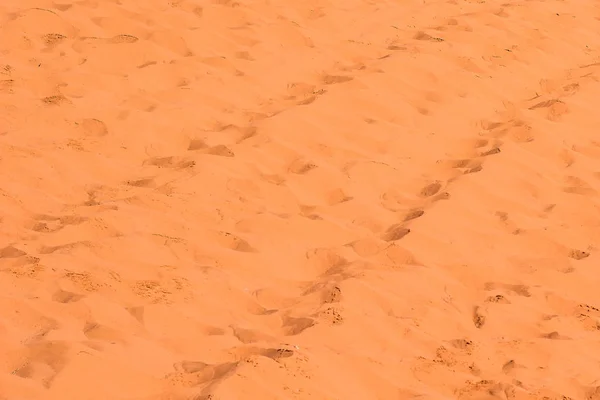 Deserto sabbia ondulato sfondo superficie strutturata con le scarpe passi stampe su un terreno — Foto Stock