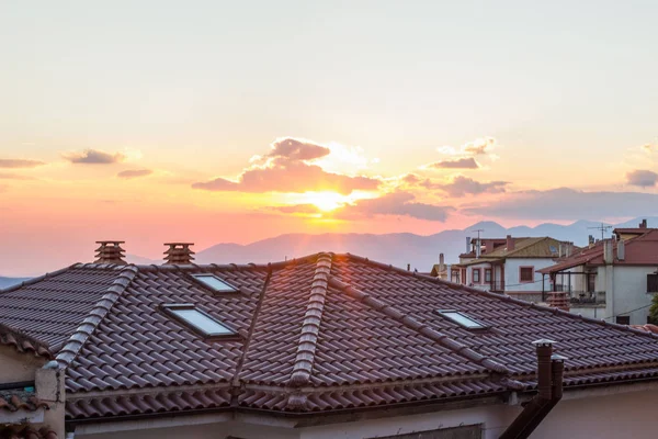 Şehir simgesi kiremitler çatılar ve akşam gün batımı ışınları ışık ve parıltı