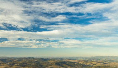panoramic moody aerial landscape of highland valley hill land scenic environment cloudy blue sky background wallpaper nature photography with empty copy space for your text here