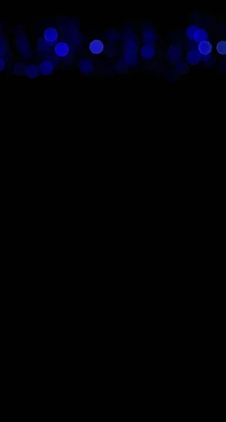 Вертикальный рисунок темно-синий боке искры на черном фоне обои пространство для копирования или текст — стоковое фото