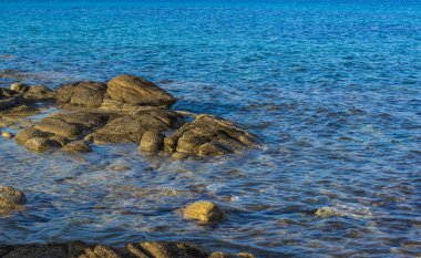 picturesque vivid colors landscape rocky stone shore line of reservoir blue water nature simple background scenic view