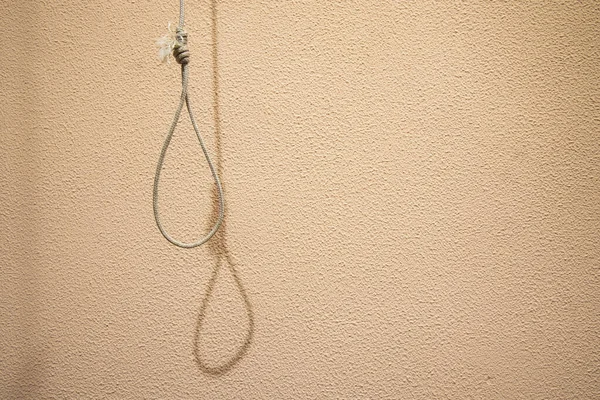 thread loop hanging suicide domestic death concept on soft pink glamour style background wall depression wallpaper pattern picture with empty copy space for your text here