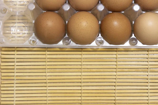 raw eggs in plastic box tray animal product shop concept background picture on small wooden sticks shelf copy space