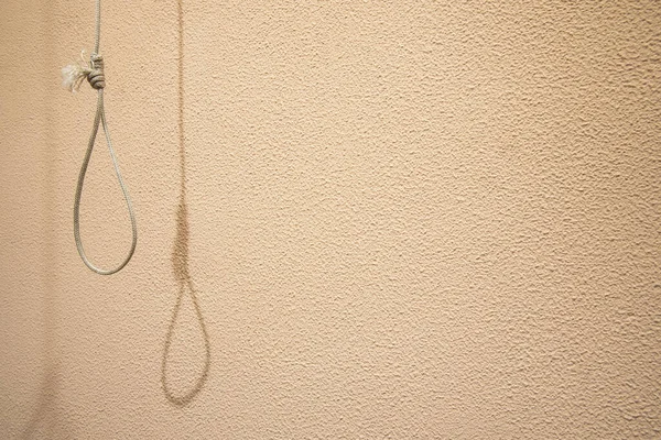 hanging loop suicide tool object with shadow on concrete texture simple background pattern space for copy or your text here