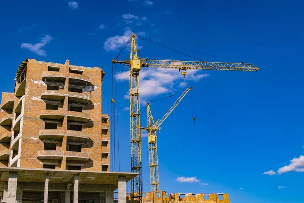 poster construction building landmark object brick exterior shape and high crane on vivid blue sky background space
