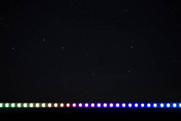 night star sky long exposure background photography with different colorful festive carnival lamps illumination frame work foreground poster picture concept copy space