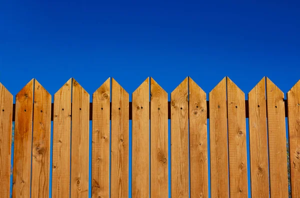 yard wooden fence palisade garden object vivid blue sky background and empty copy space for your text here