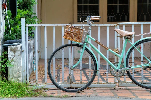 Old bicycle with blank basket park,Bicycle wheel close up vintag