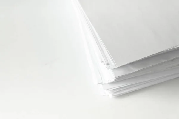 blank papers on white table,blank stack documents paper on office desk.