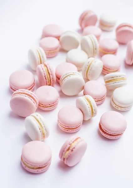 Tender pink and white macarons on white background. Natural light. Selective focus — Stock Photo, Image