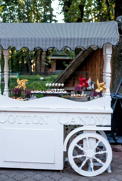 Cotton Candy cart with candy bar desserts and delicious sweets. Halloween decor.