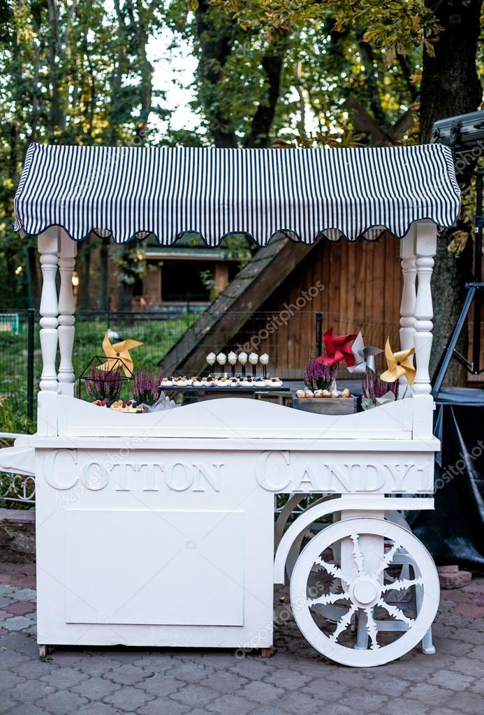 Cotton Candy cart with candy bar desserts and delicious sweets. Halloween decor.
