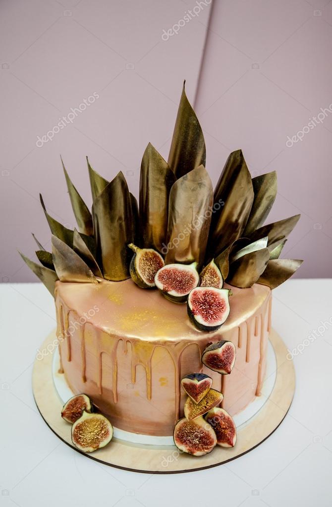 Trendy modern chocolate caramel layered cake decorated with chocolate