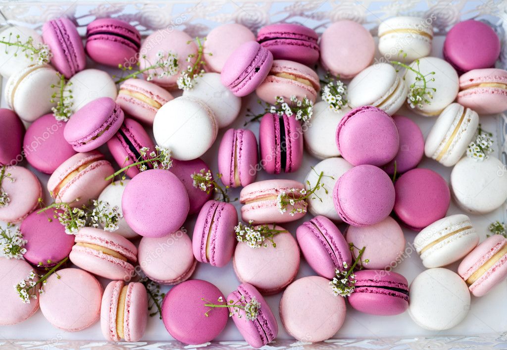 White tray full of colorful macarons shades of pink. Natural light. Selective focus.