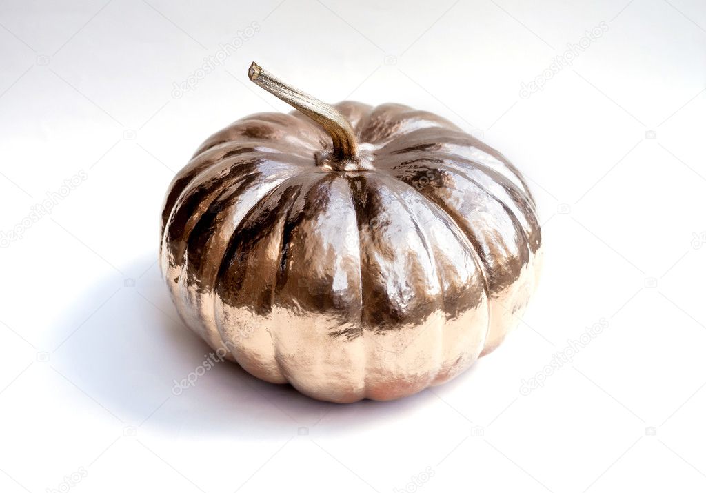 Halloween pumpkin painted in gold. Holiday decoration.