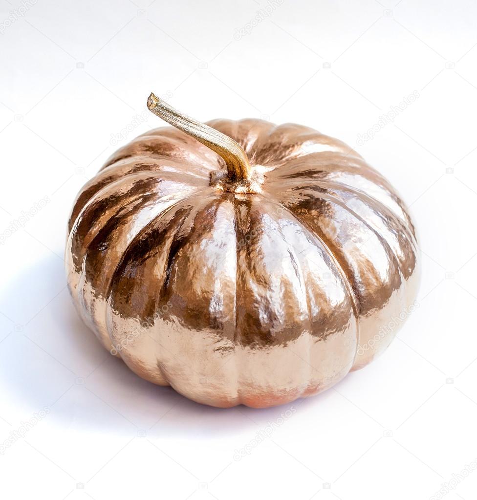 Halloween pumpkin painted in gold. Holiday decoration.