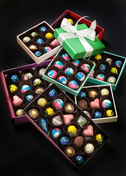 Chocolate handmade candy sweets in a gift boxes. Black background. — Stock Photo, Image