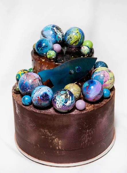 Modern trendy 2-tier layered cake with chocolate hand painted planets and rocket on a white background. — Stock Photo, Image