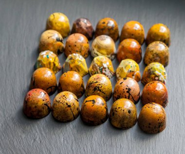 Çikolata el lüks şeker bonbon üzerinde siyah arduvaz arka plan yapımı.