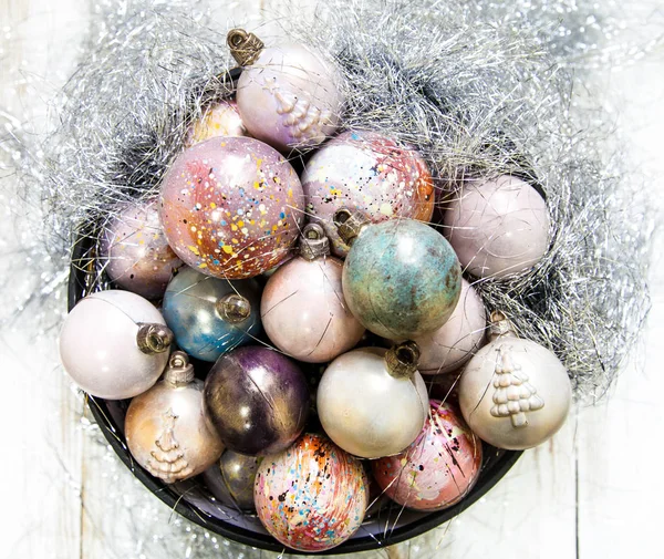 Christmas hand painted chocolate candy balls and on a wooden black tray. — Stock Photo, Image