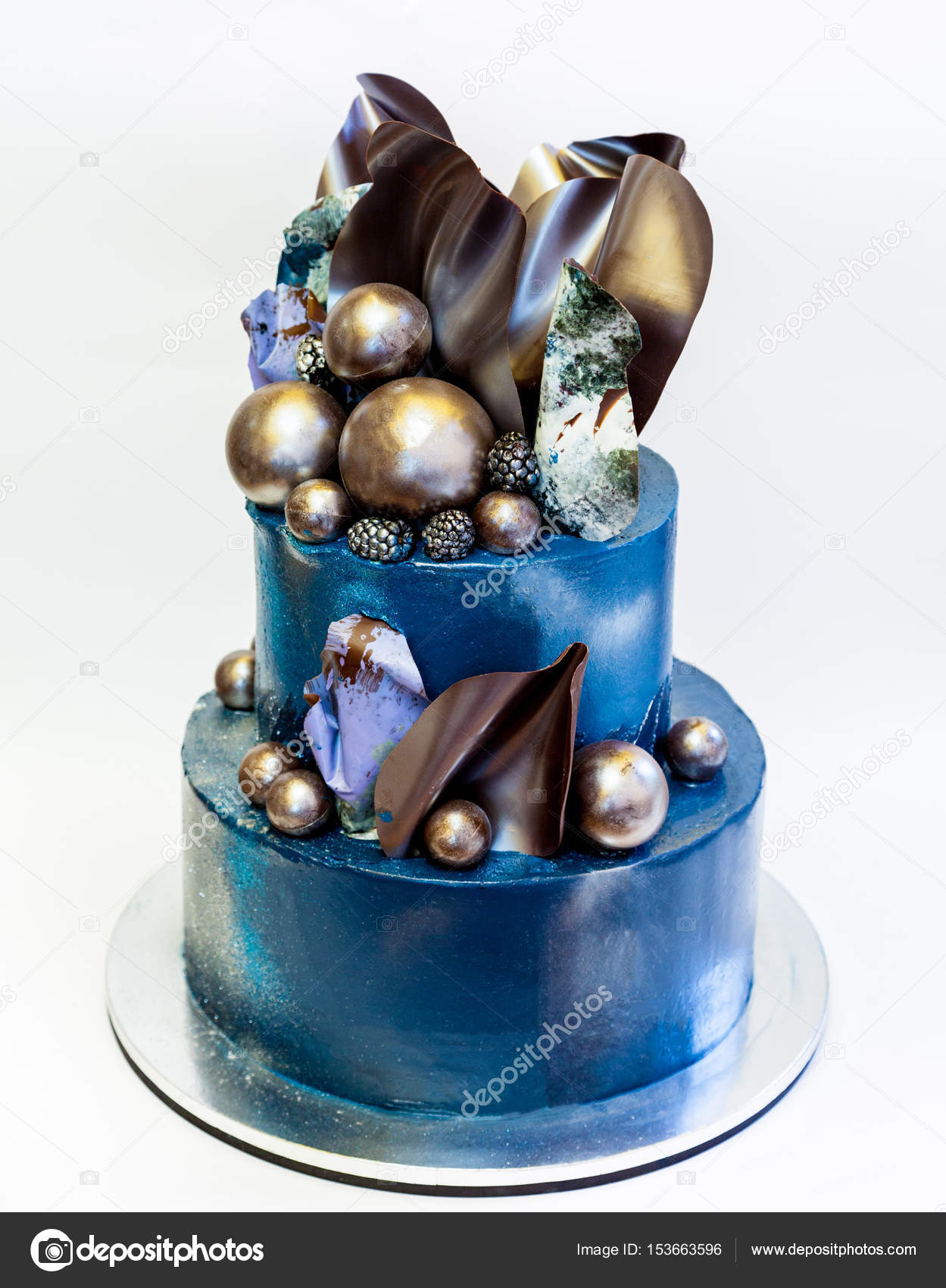 Creative wedding tiered cake decorated with chocolate waves and ...