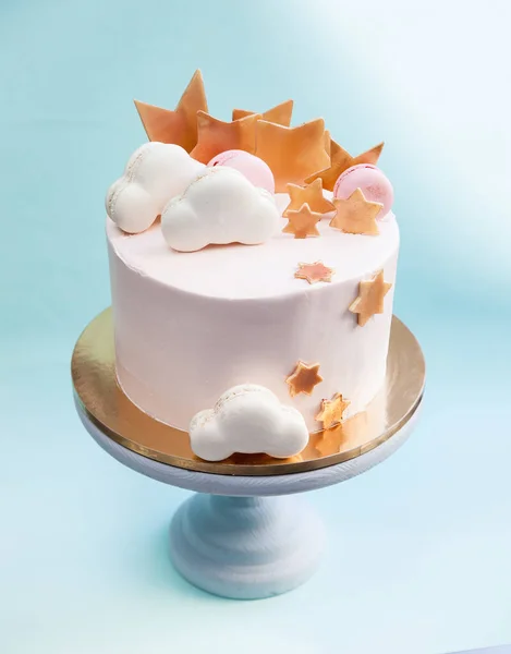 Birthday layered cake with macaron clouds and chocolate golden stars