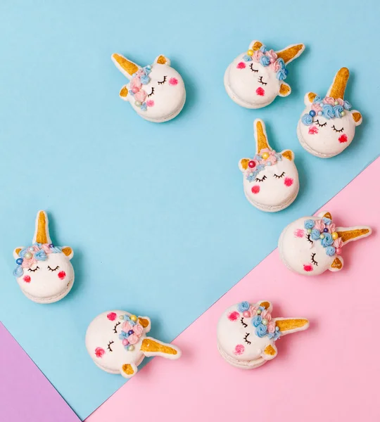Unicorn macaron cookies on a geometric pastel background
