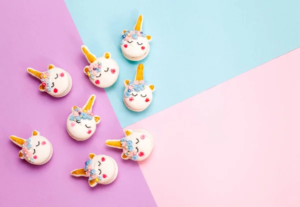 Unicorn macaron cookies on a geometric pastel background