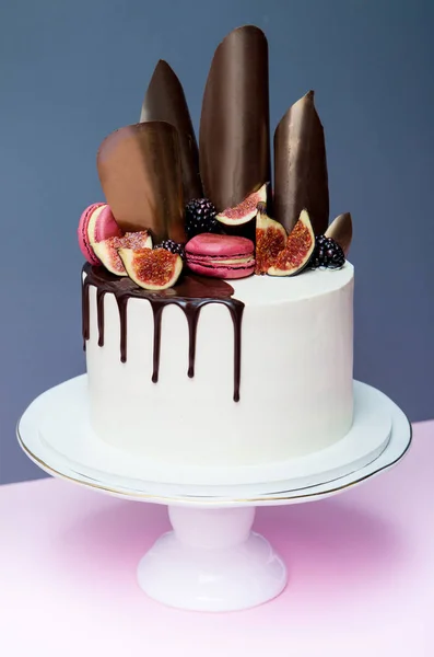 Cake decorated with chocolate waves, pink macaron and fresh figs — Stock Photo, Image