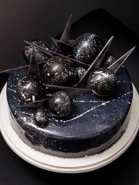 Kara kozmik cake çikolata topları ile dekore edilmiştir. 