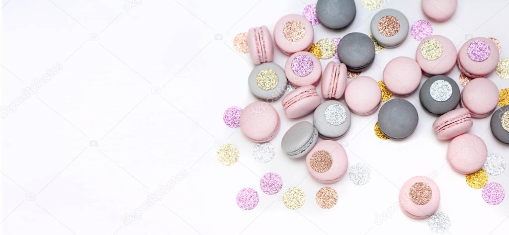 Pastel color macaron cookies with sparkling decoration. Isolated on white