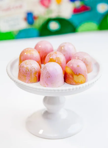 Candy bonbons on a white small cake stand