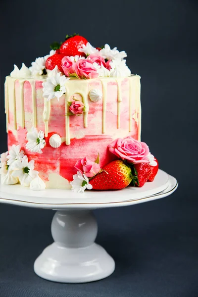 Strawberry cake on a white cake stand